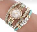 Gold watch with a green bracelet, strap wrapped