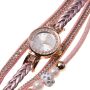 Gold watch with a pink bracelet, strap wrapped