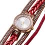 Gold watch with a red bracelet, strap wrapped
