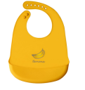 Silicone bib with a pocket for children - orange, banana pattern